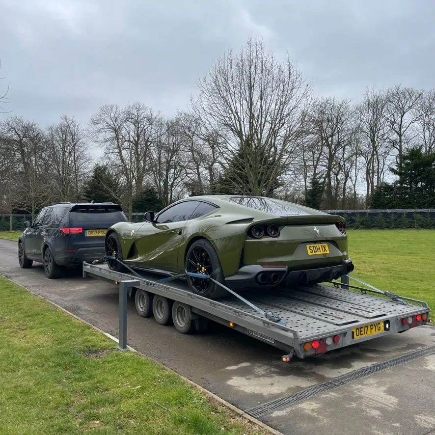 Green Ferrari being transported